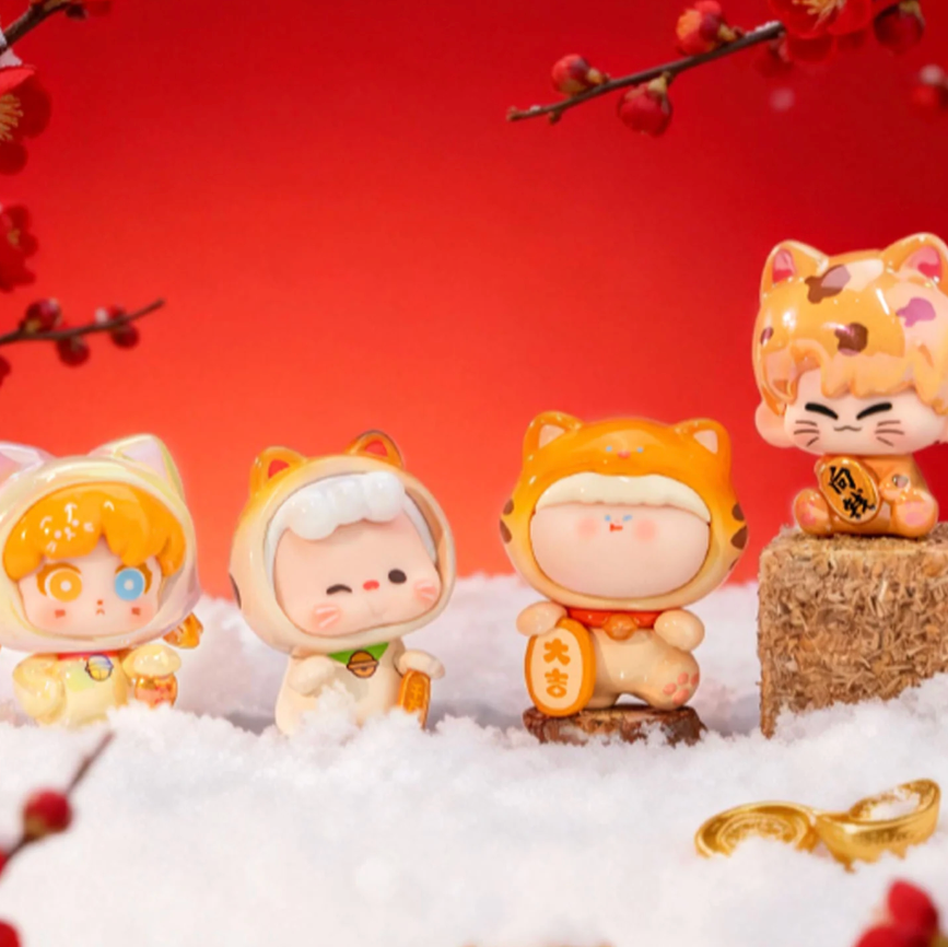 Four cat-themed figurines with a red background and cherry blossoms.
