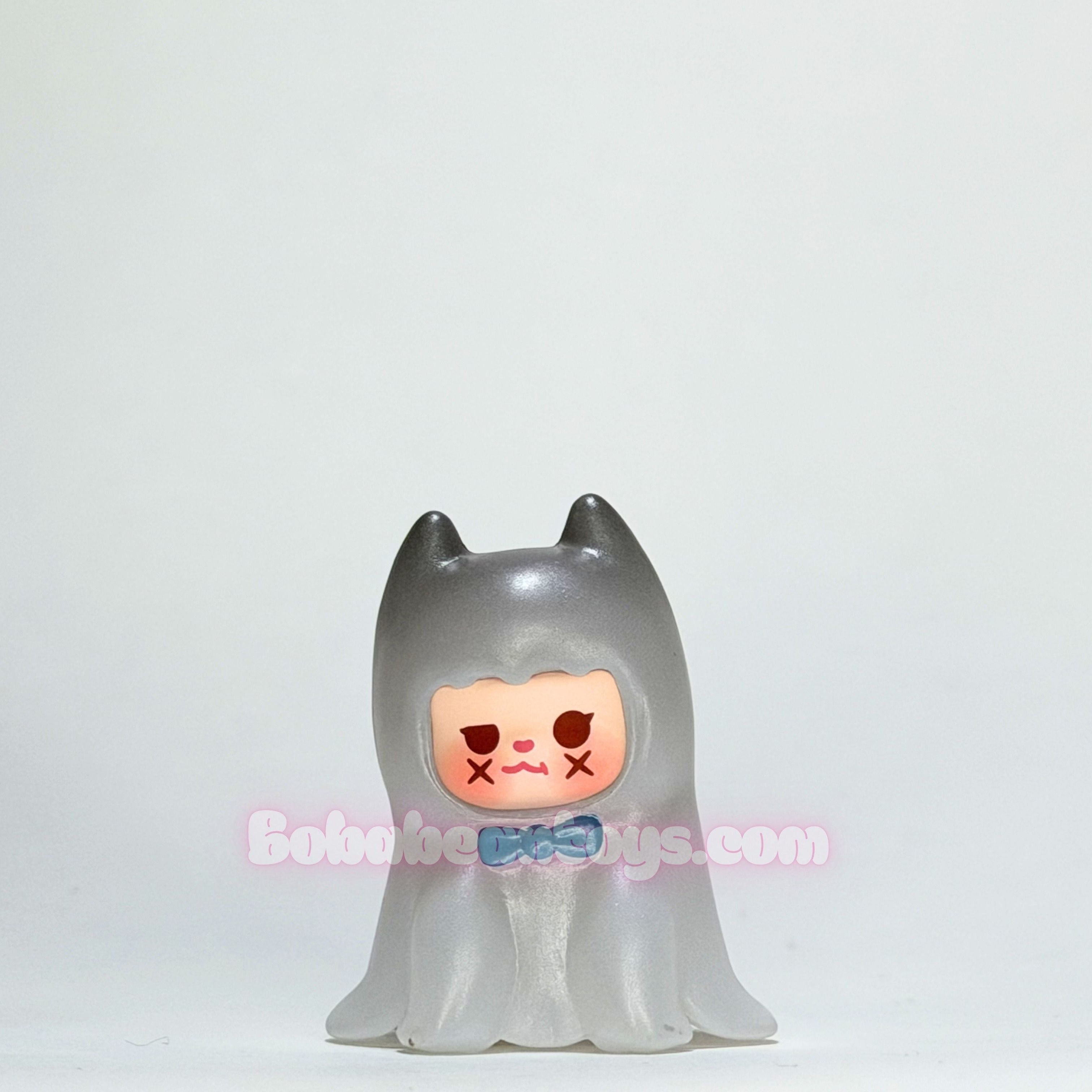 Toy figure with a ghost-like design on a white background