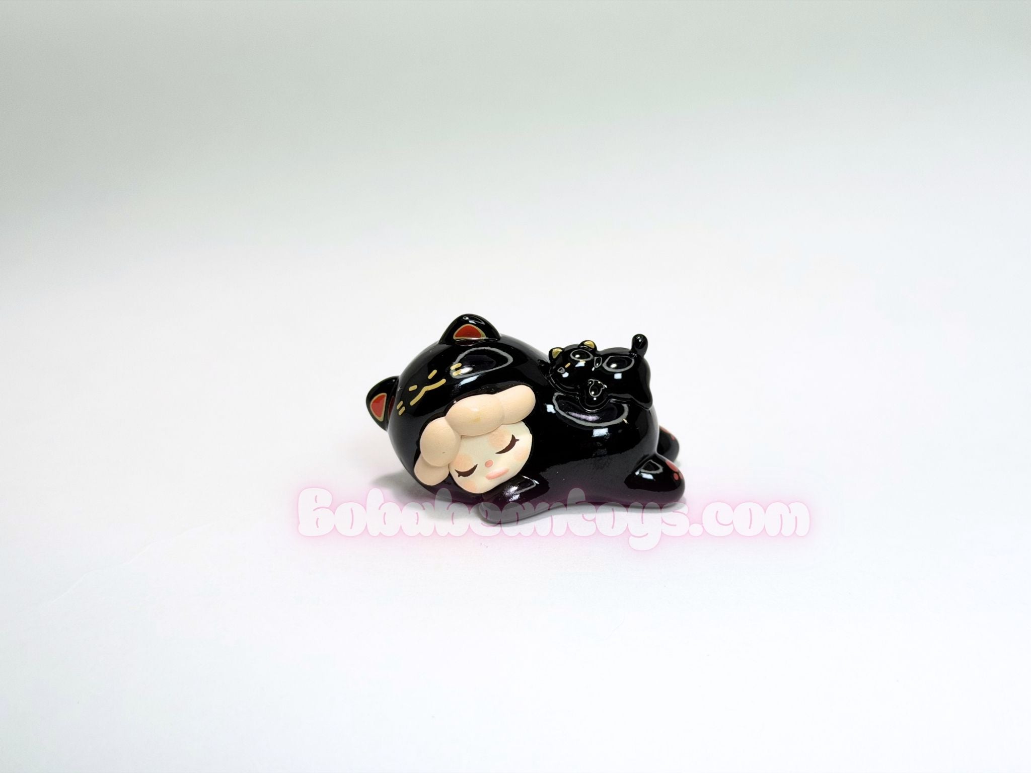 Black cat-shaped figurine on a white background