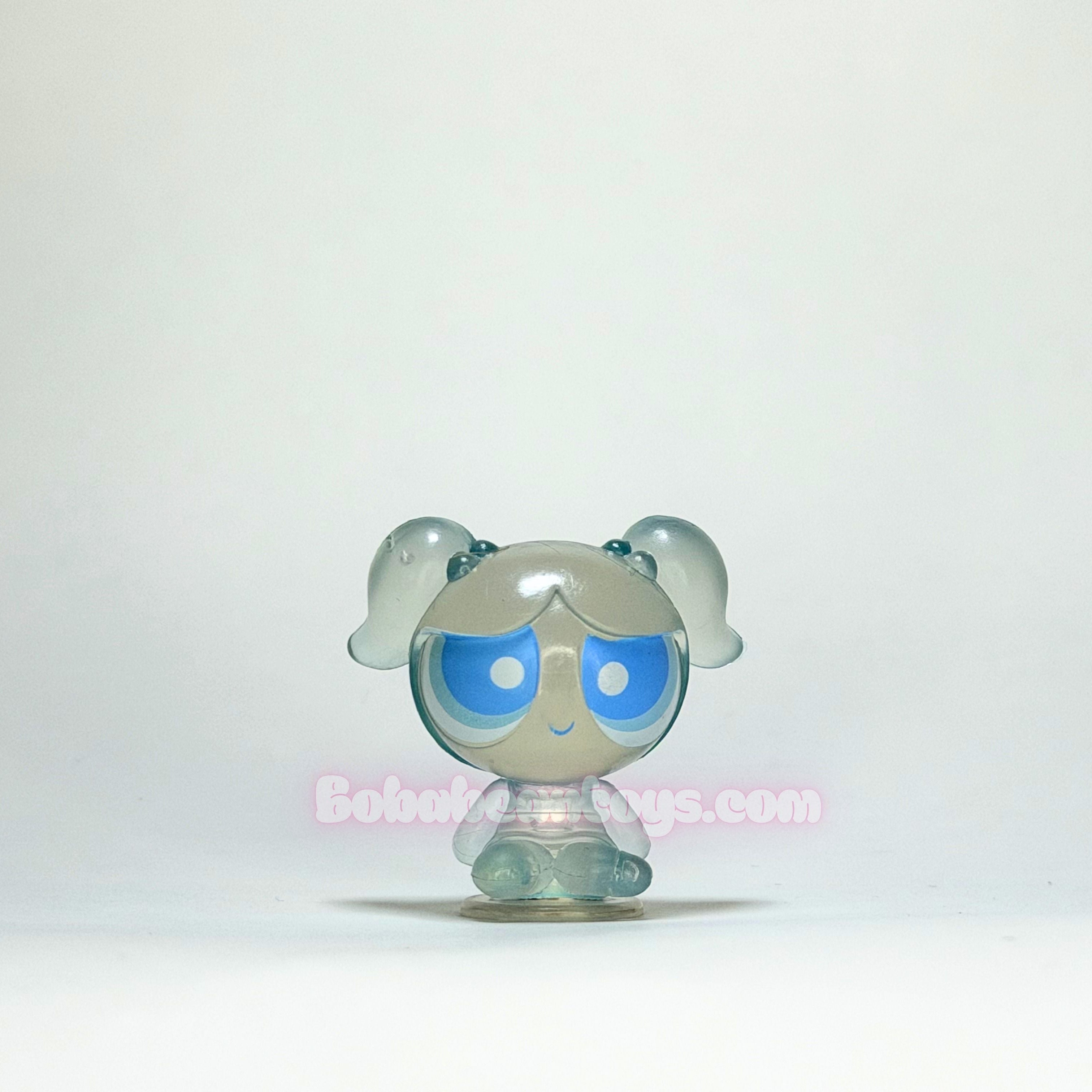 Small transparent figurine with blue eyes on a white background