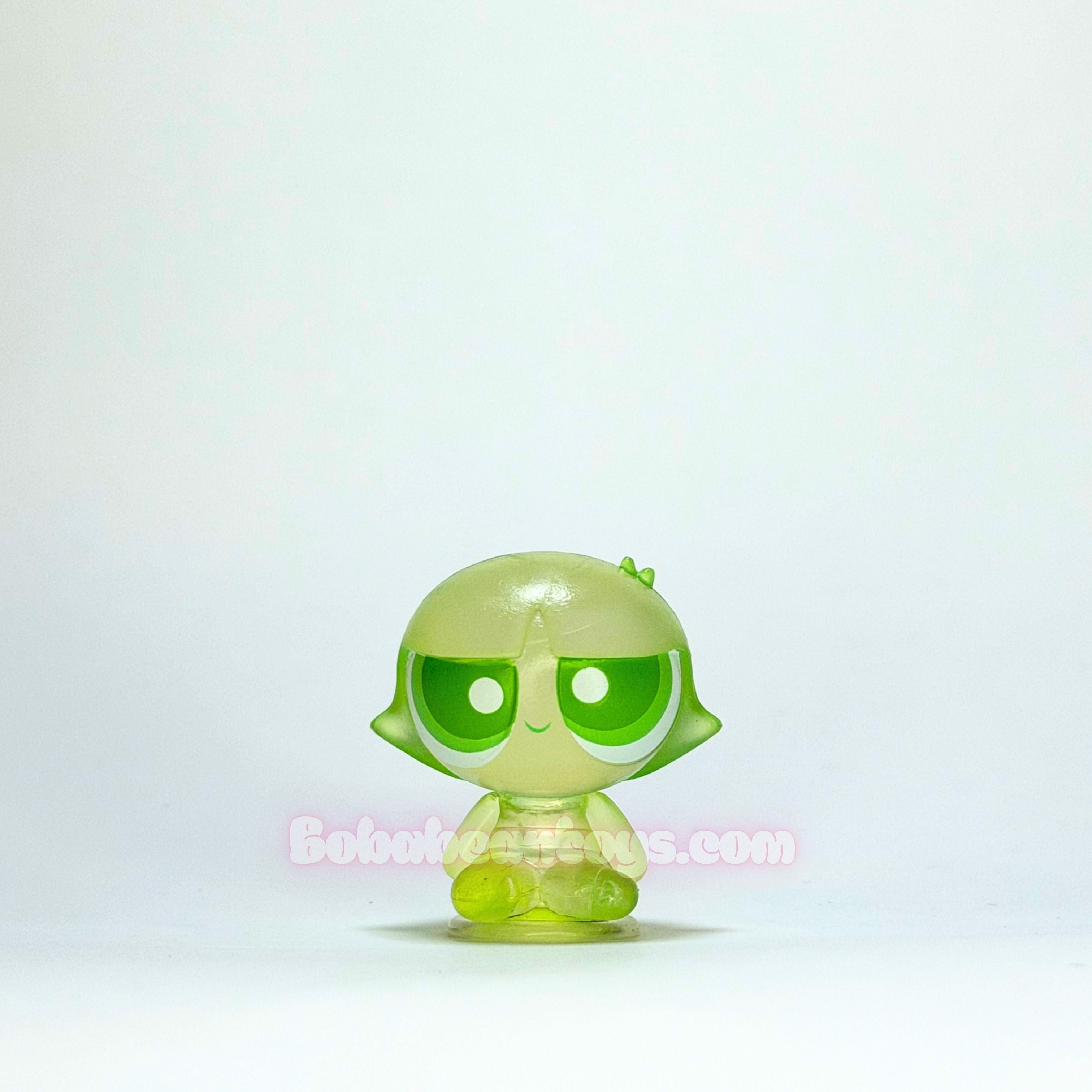 Green toy figure with a plain white background