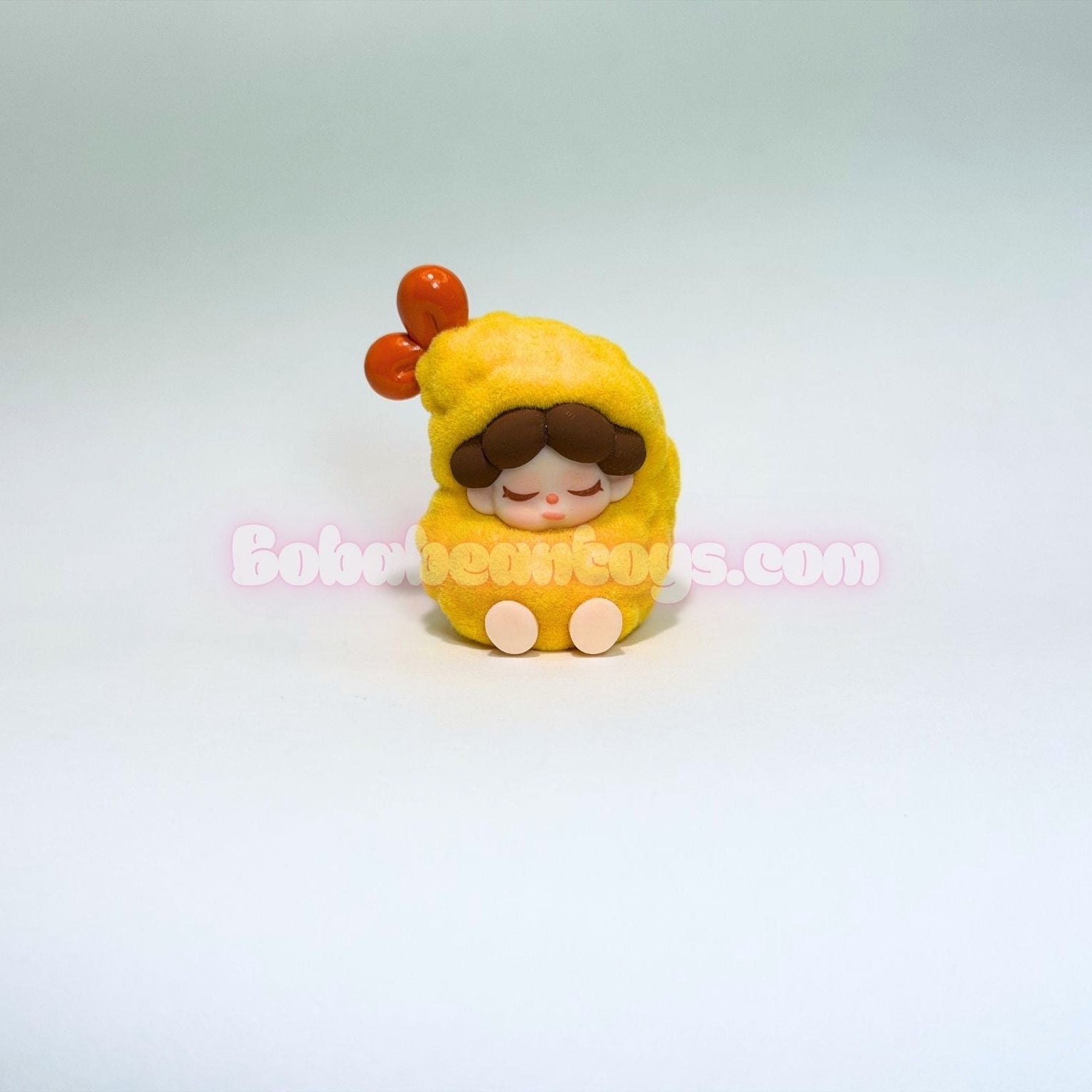 Small figurine of a character dressed as a shrimp with a red hat on a light gray background.