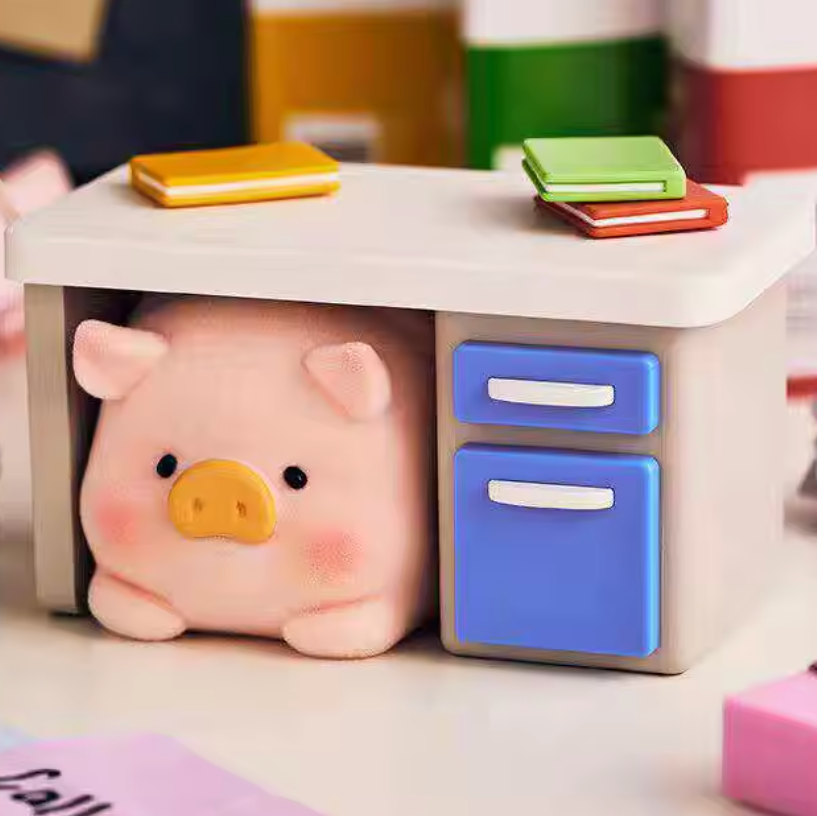Small desk with a piggy and stationery items on a blurred background