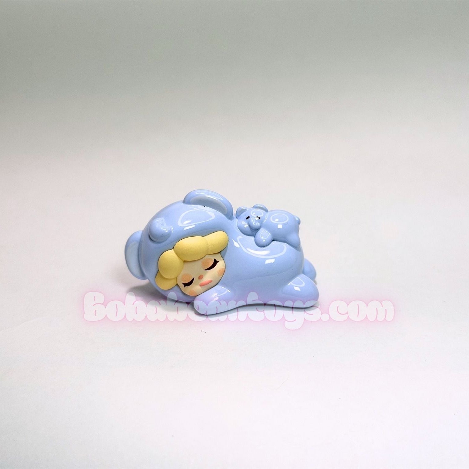 Toy figure of a elephant in a blue outfit with a white background