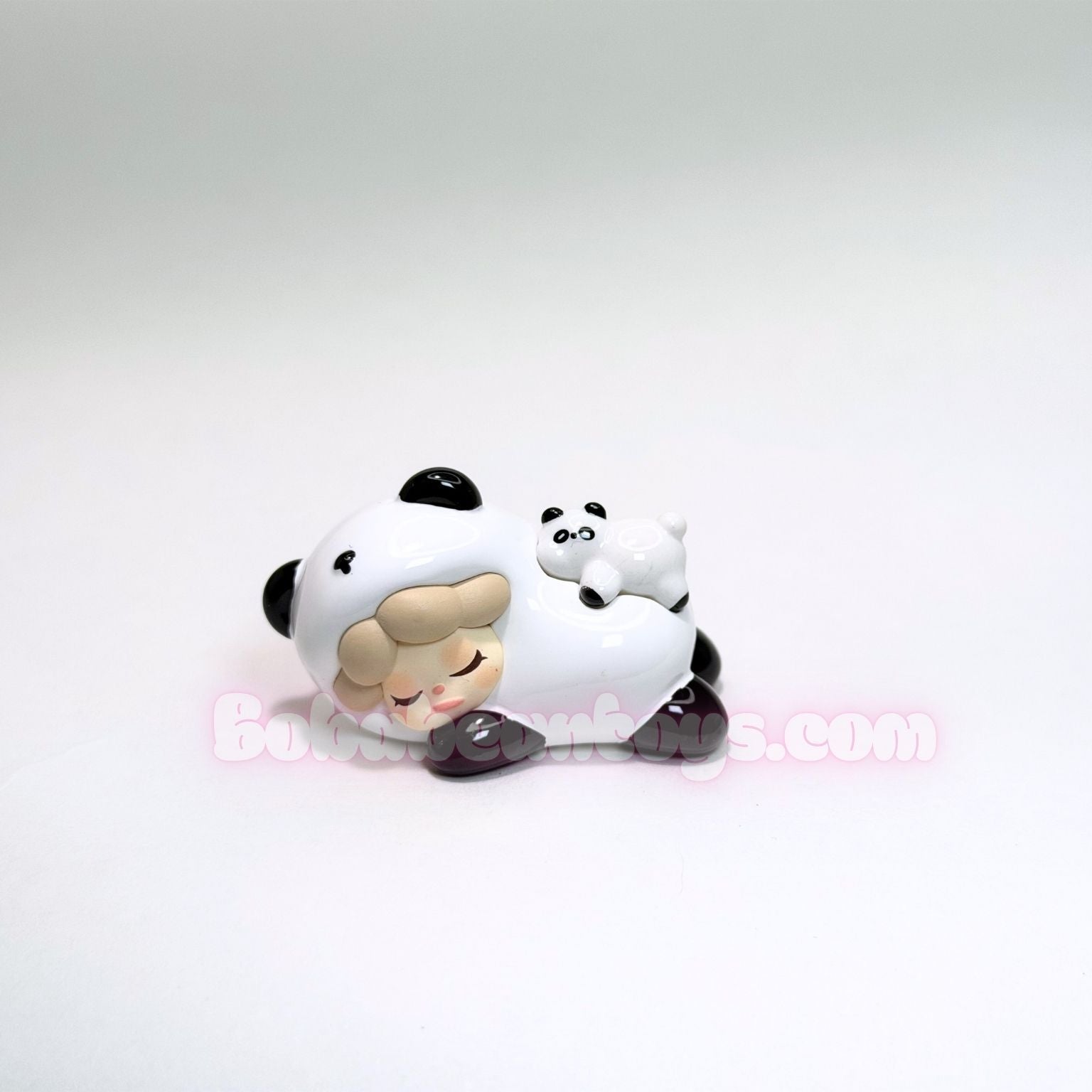 Two panda figurines on a white background