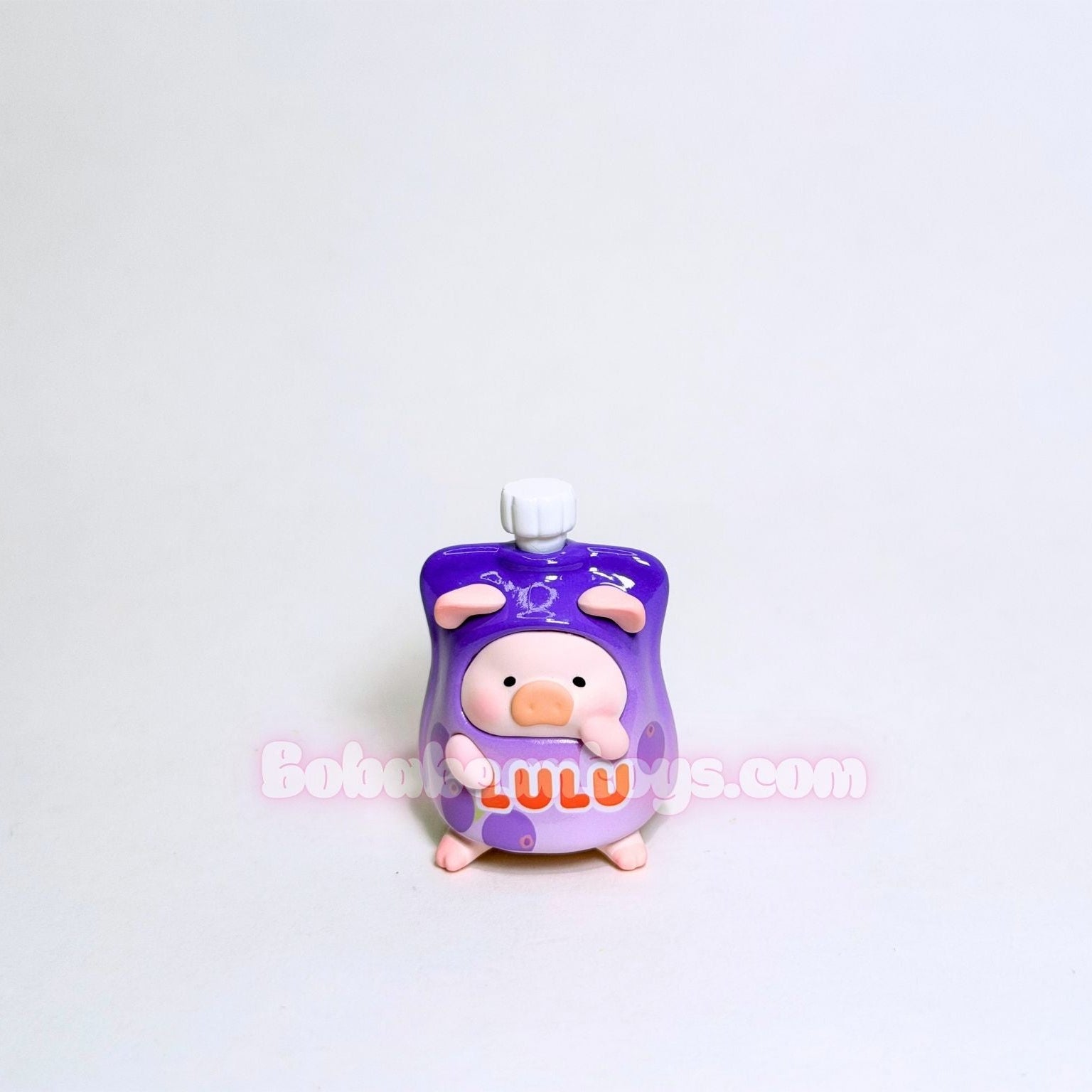 Purple character figurine with 'Lulu' text on a white background