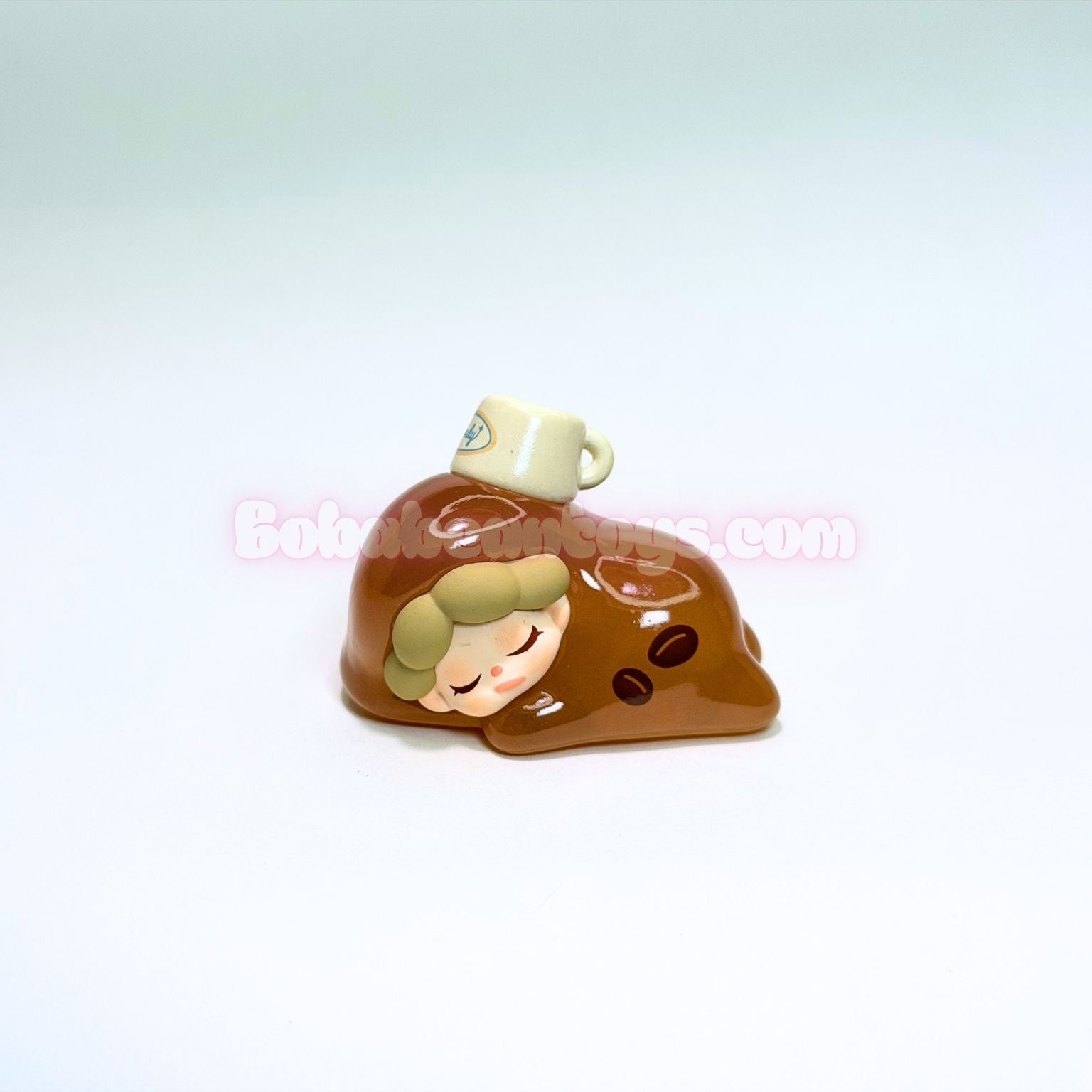 Small figurine of a person with a cup on their head against a white background