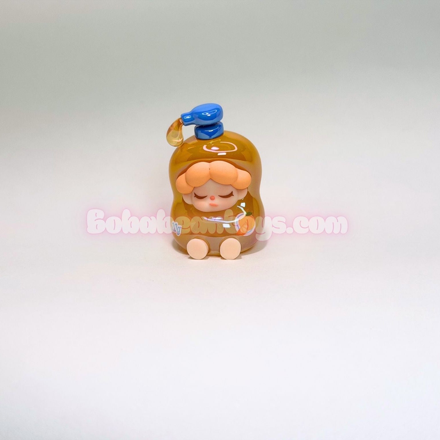 Small figurine of a character as an orange soap bottle on a white background
