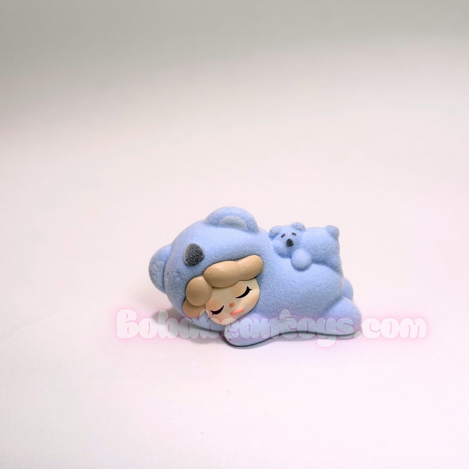 Blue koala bear plush toy with a face on a white background