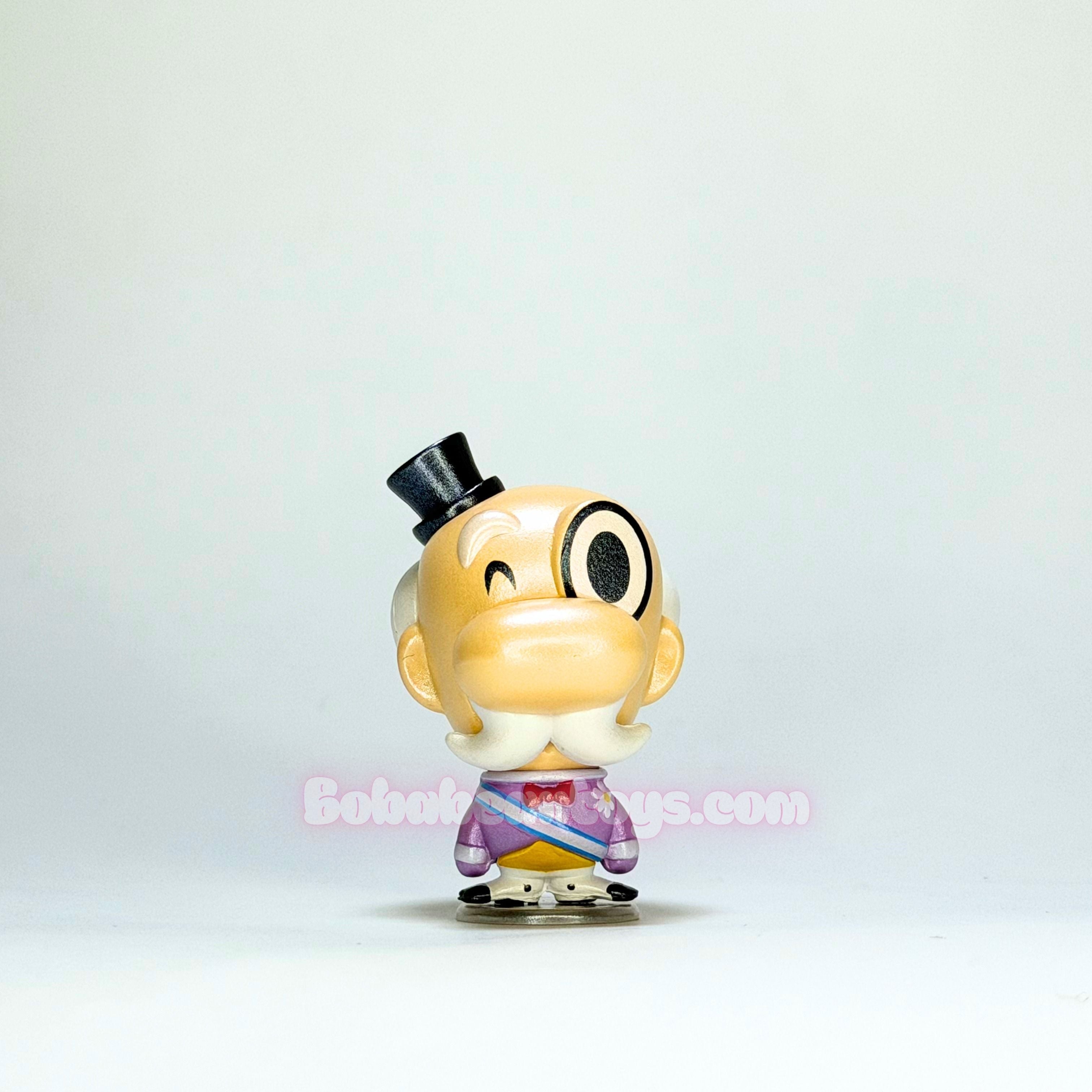 Small figurine with a top hat on a light gray background