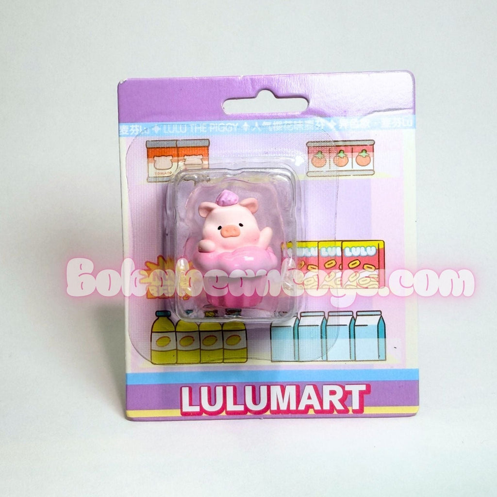 Pink piggy bank figure in packaging with Lulumart branding on a white background