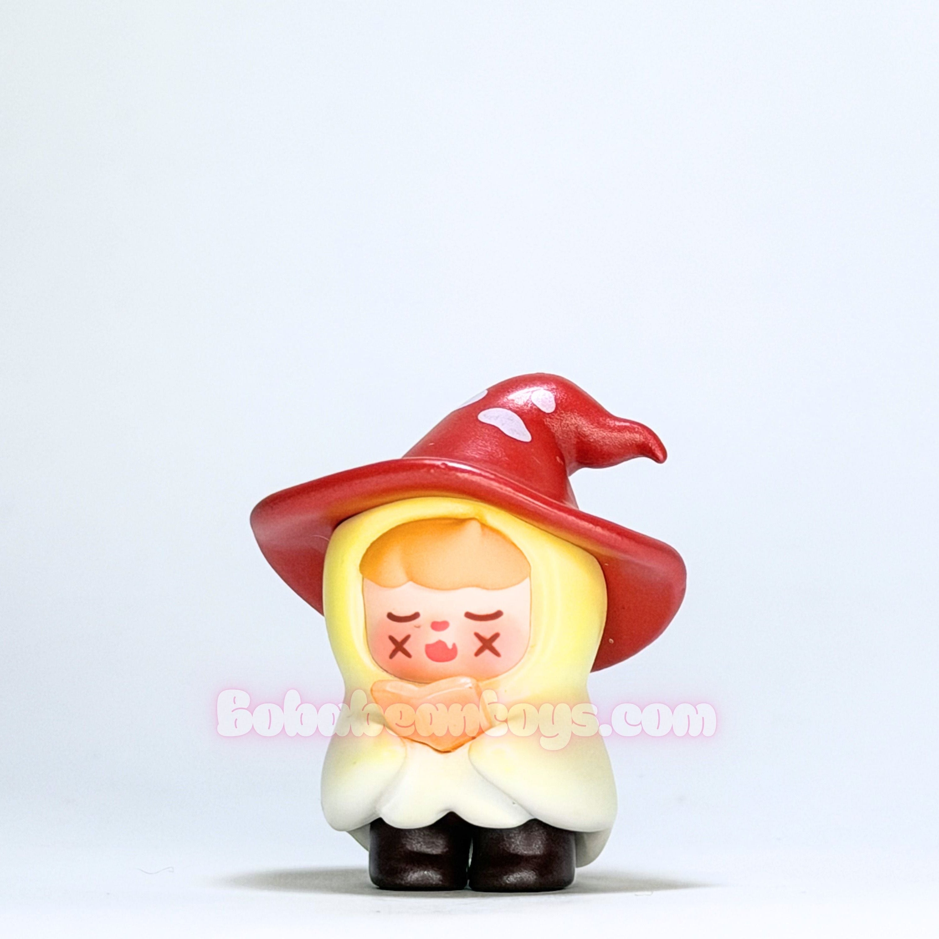 Toy figure of a character with a red hat and yellow face on a white background