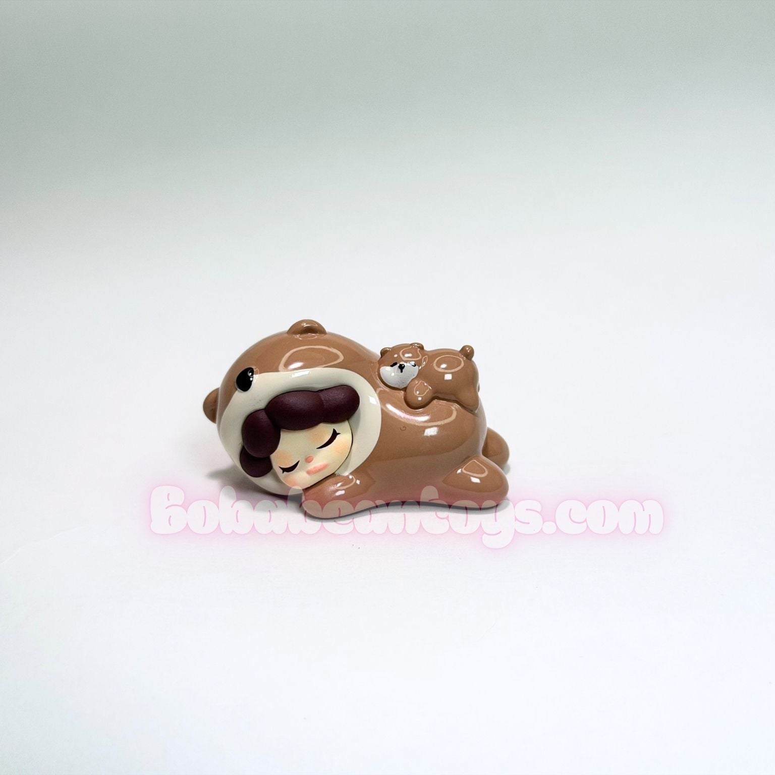 Small figurine of an otter with a neutral background