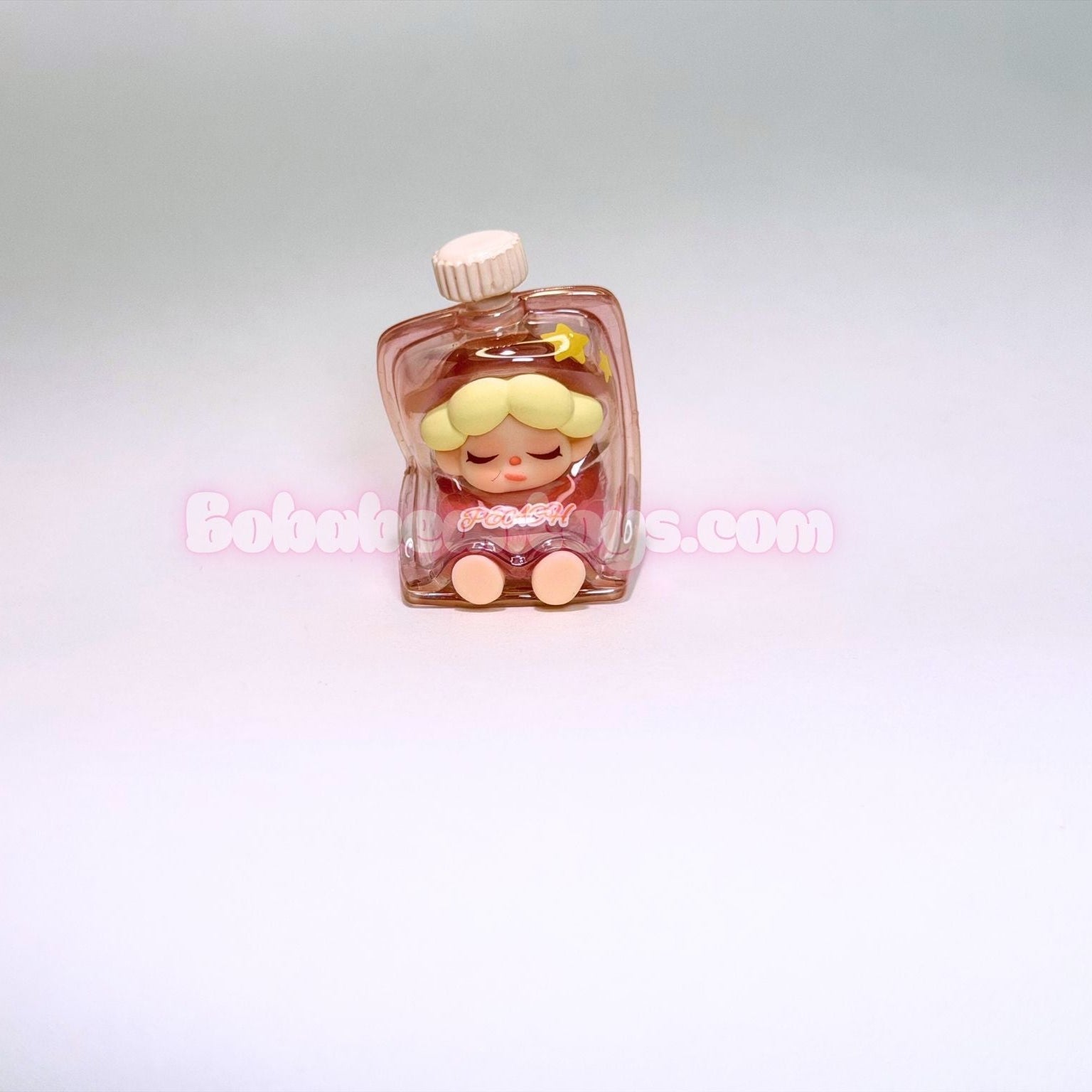Small figurine of a blonde character with a pink bottle on a light gray background