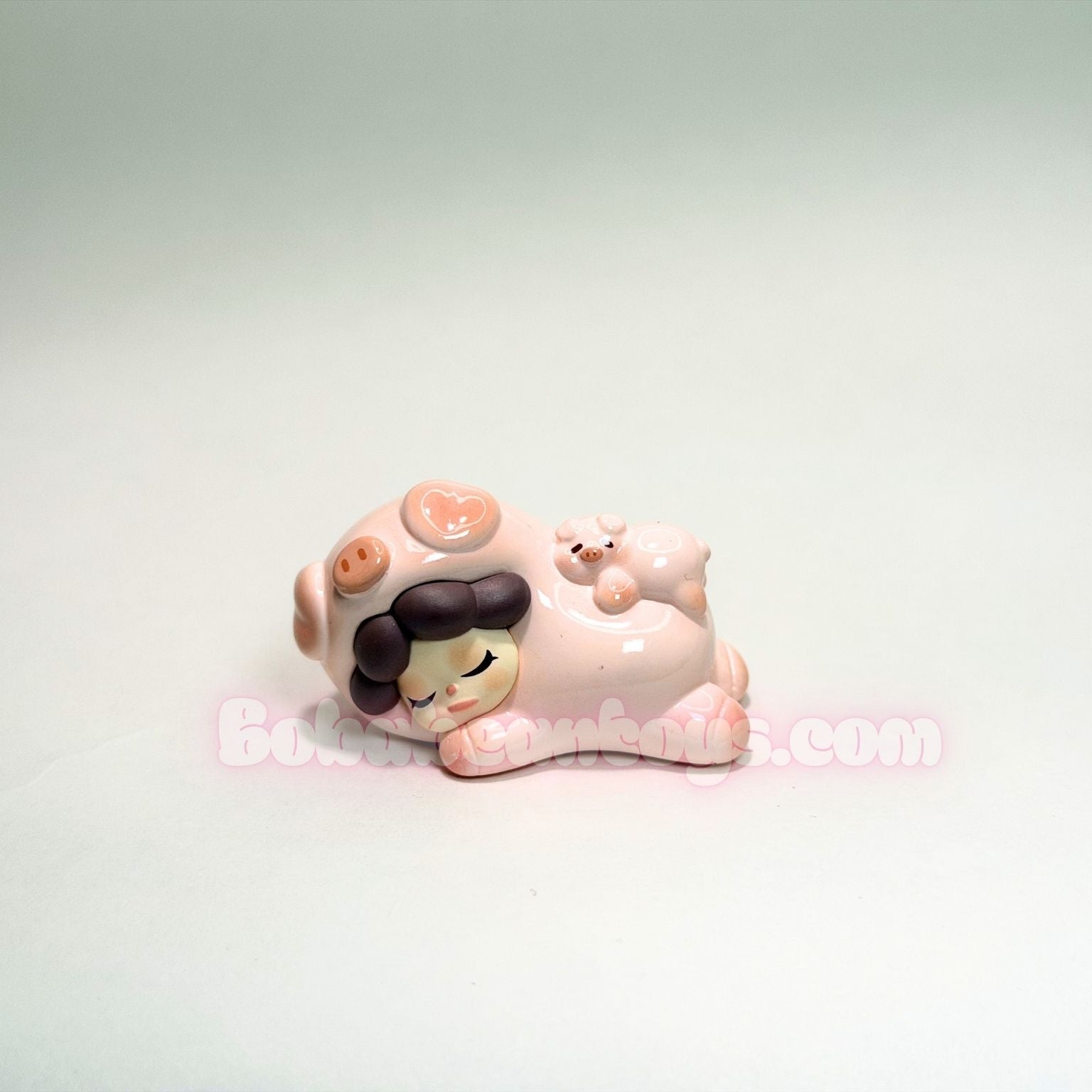 Small ceramic piggy character on a white background