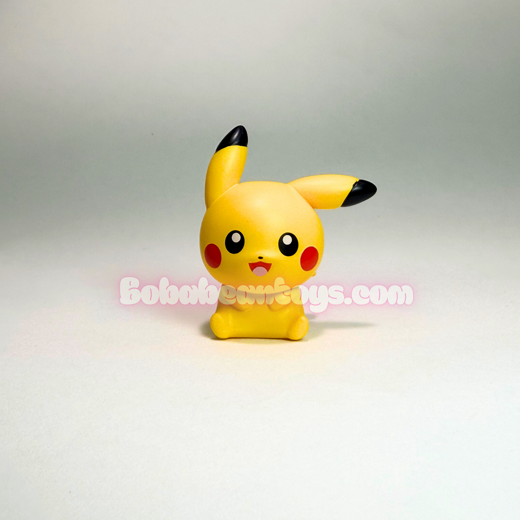 A small yellow Pikachu figurine standing upright on a light gray studio background, with black-tipped ears and cheeks, red circular cheeks, and a translucent Bob's Toys watermark across the center.