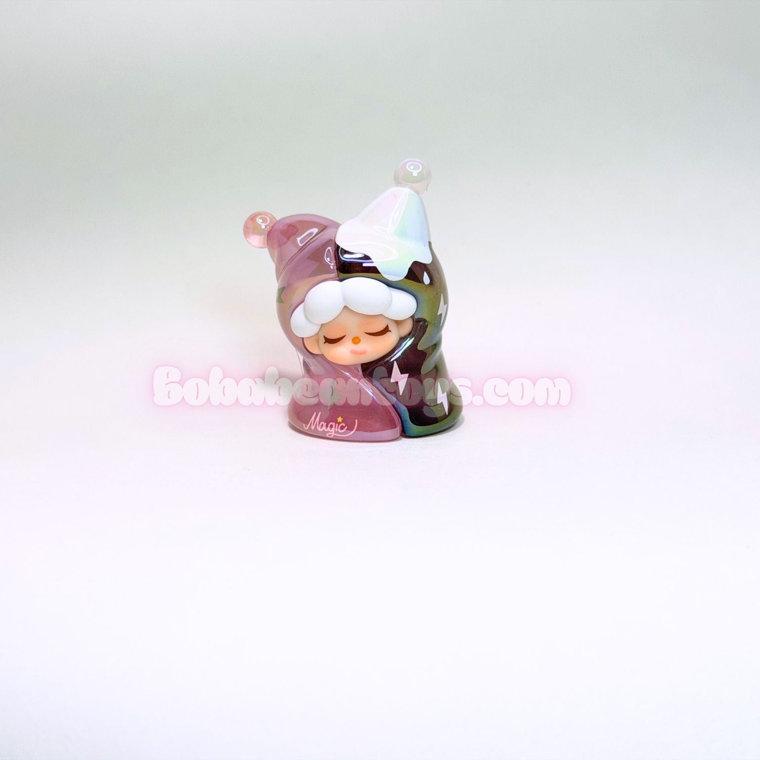 Small figurine with pink outfit and white hat on a white background