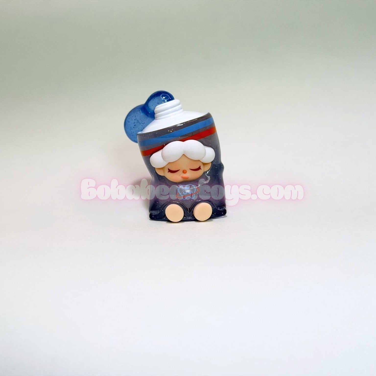 Small figurine of a character as a tube of toothpaste on a light gray background