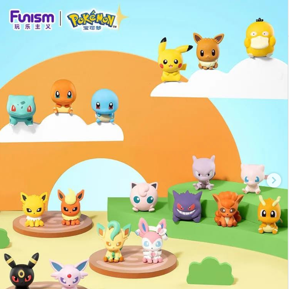 A collection of Pokémon Fuminism collectible figurines displayed on a stylized pastel landscape backdrop with clouds, hills, and water. Multiple small character figures are arranged on circular wooden platforms and floating elevated spots against a bright blue sky background.