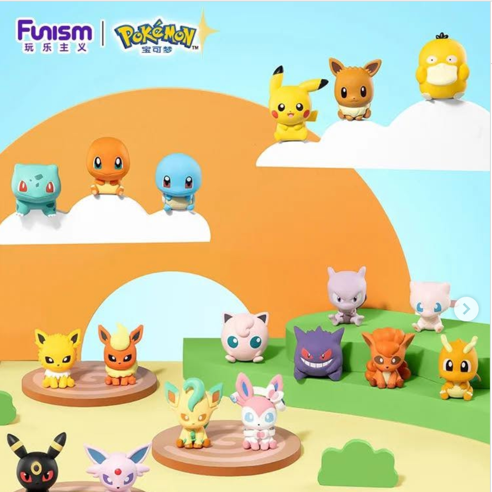 A collection of Pokémon Fuminism collectible figurines displayed on a stylized pastel landscape backdrop with clouds, hills, and water. Multiple small character figures are arranged on circular wooden platforms and floating elevated spots against a bright blue sky background.