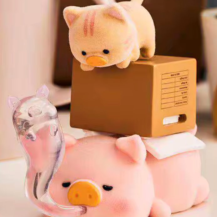 Two cute pig plush toys stacked on top of each other with a small cat plush toy on top.