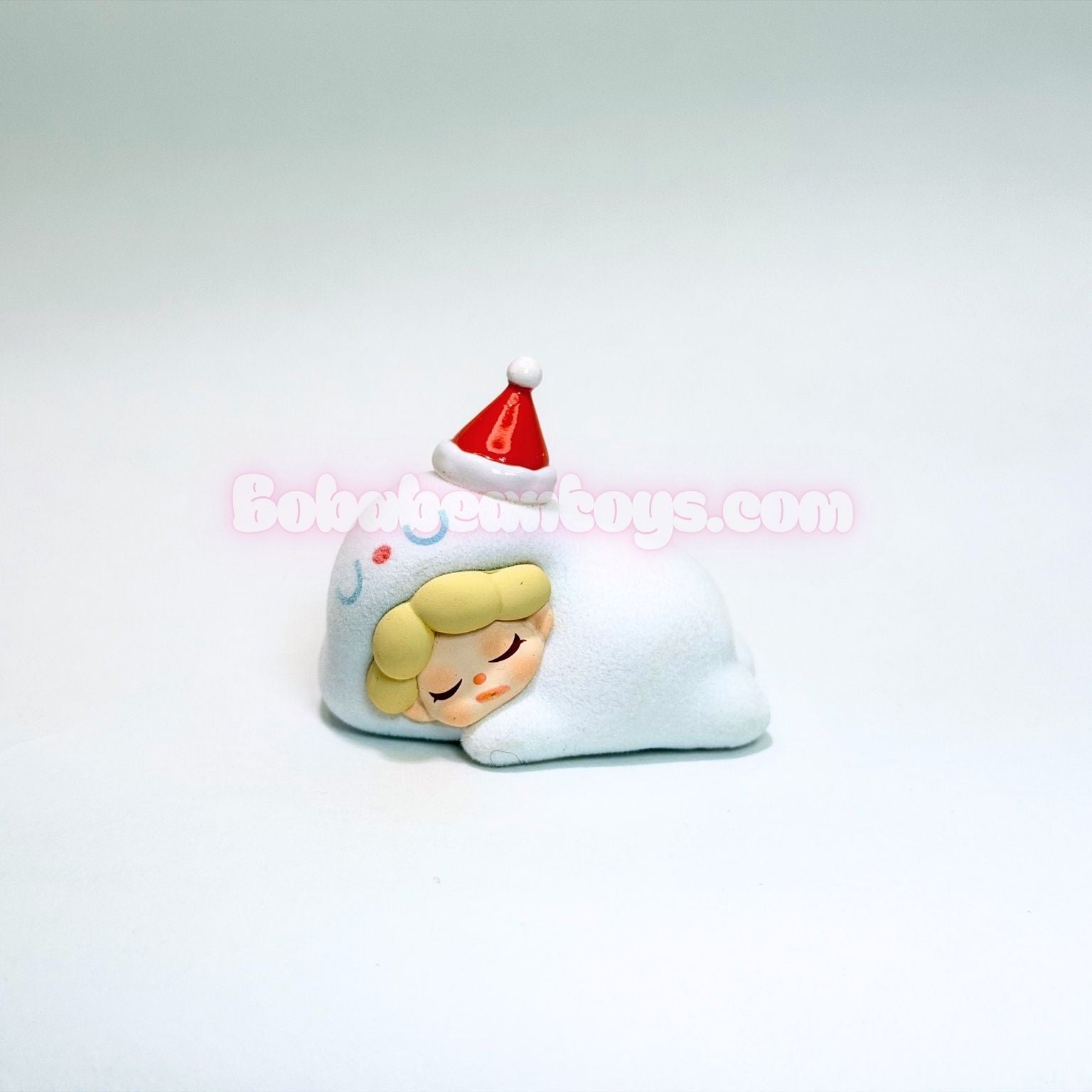 Small figurine with a red hat on a white background