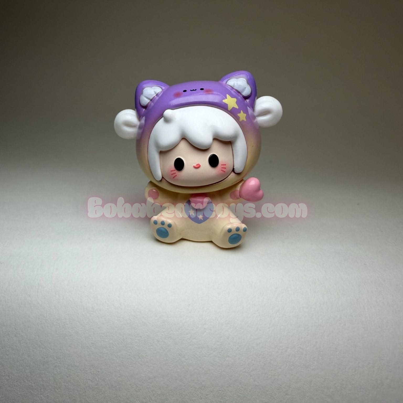 Kawaii-style figurine with a purple hat on a gray background