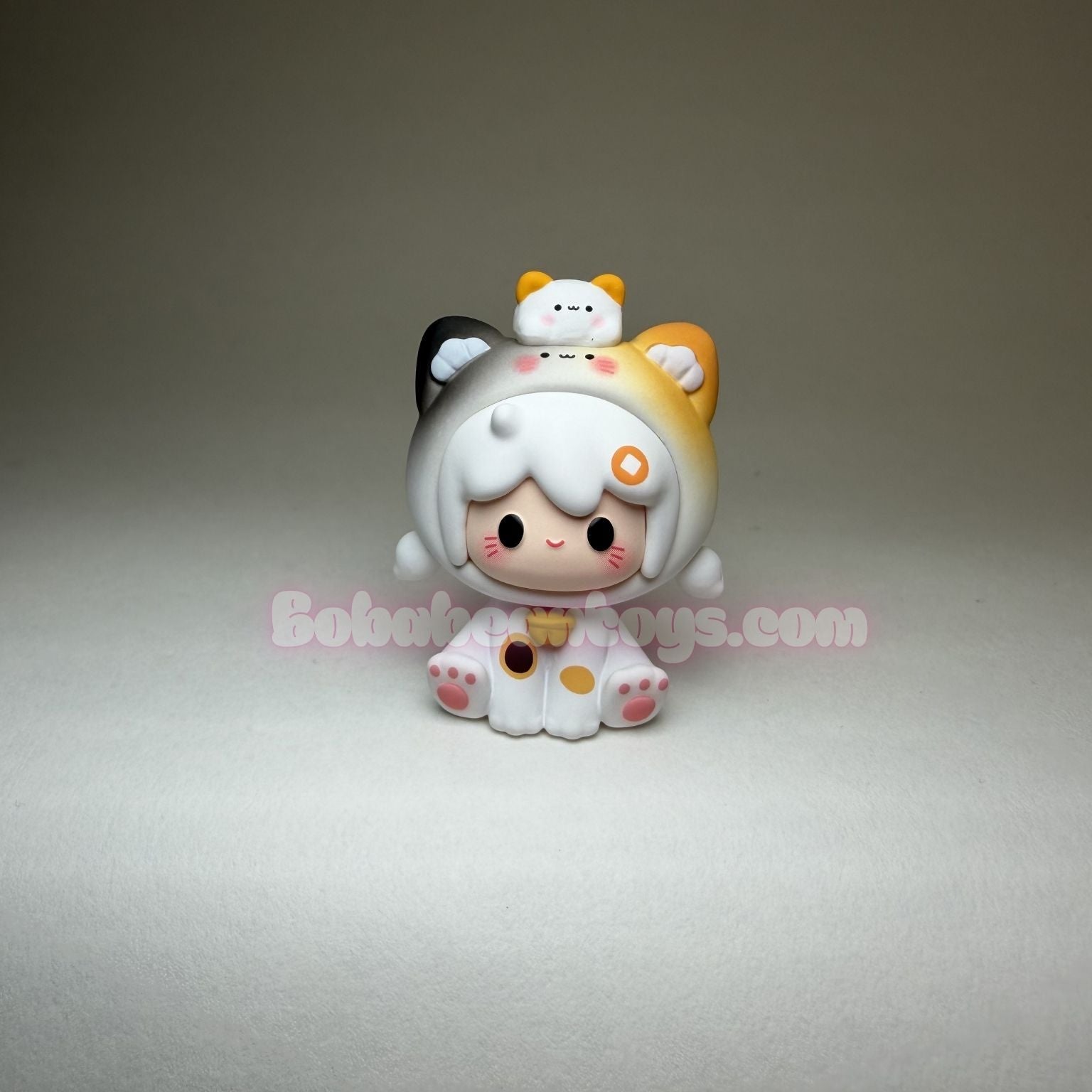 Small figurine with a white hat and orange accents on a gray background