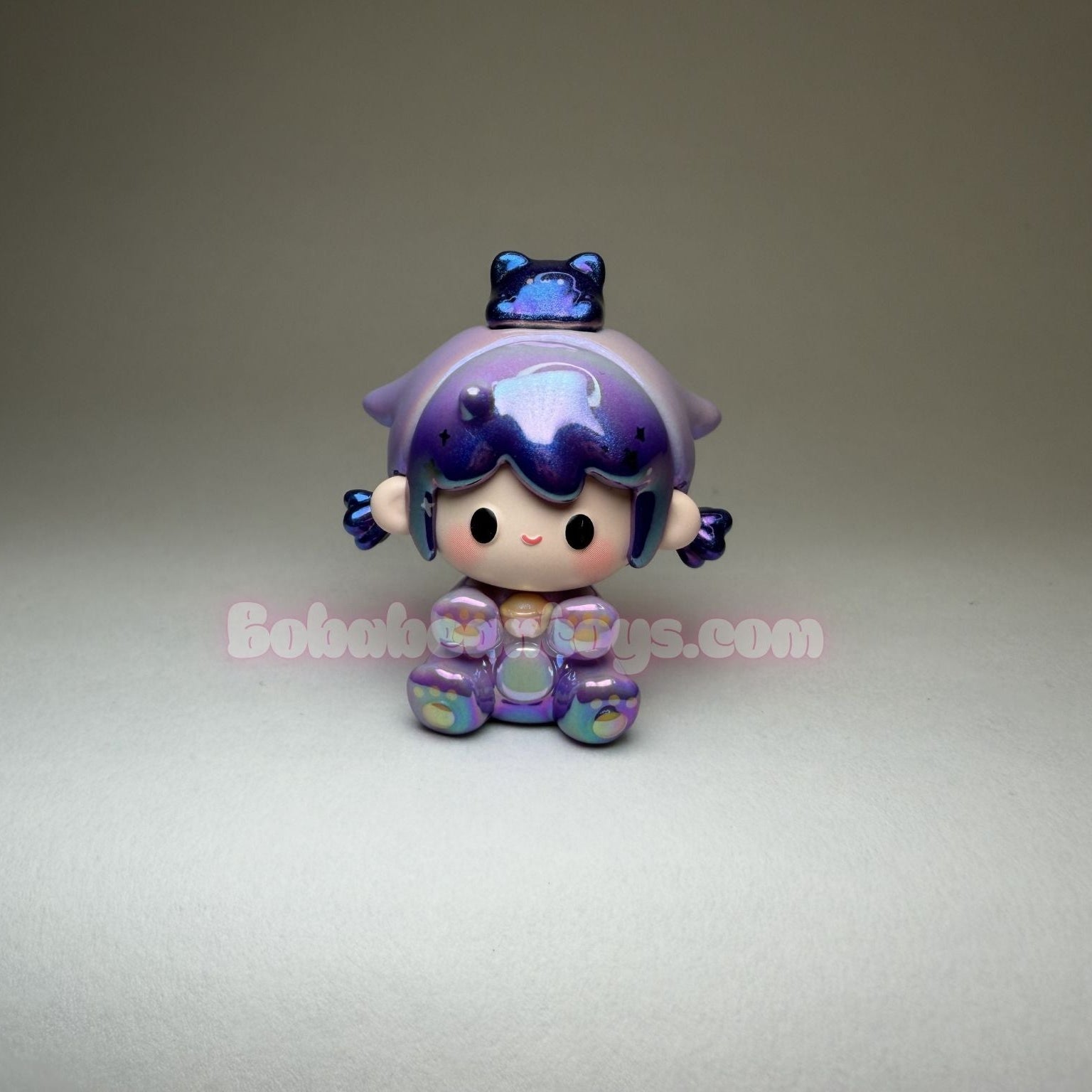 Small figurine with purple hair and outfit on a gray background
