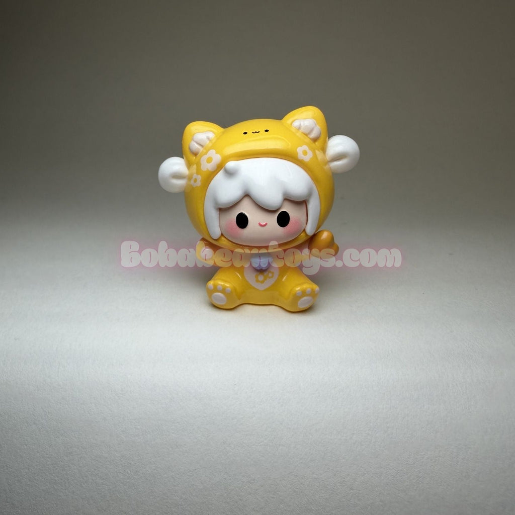 Yellow cartoon character figurine on a gray background