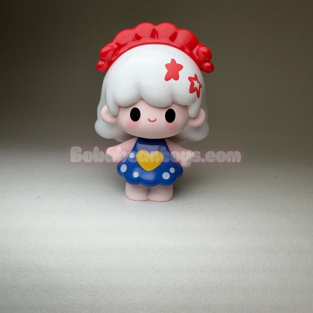 Small figurine with red hair and a blue dress on a gray background