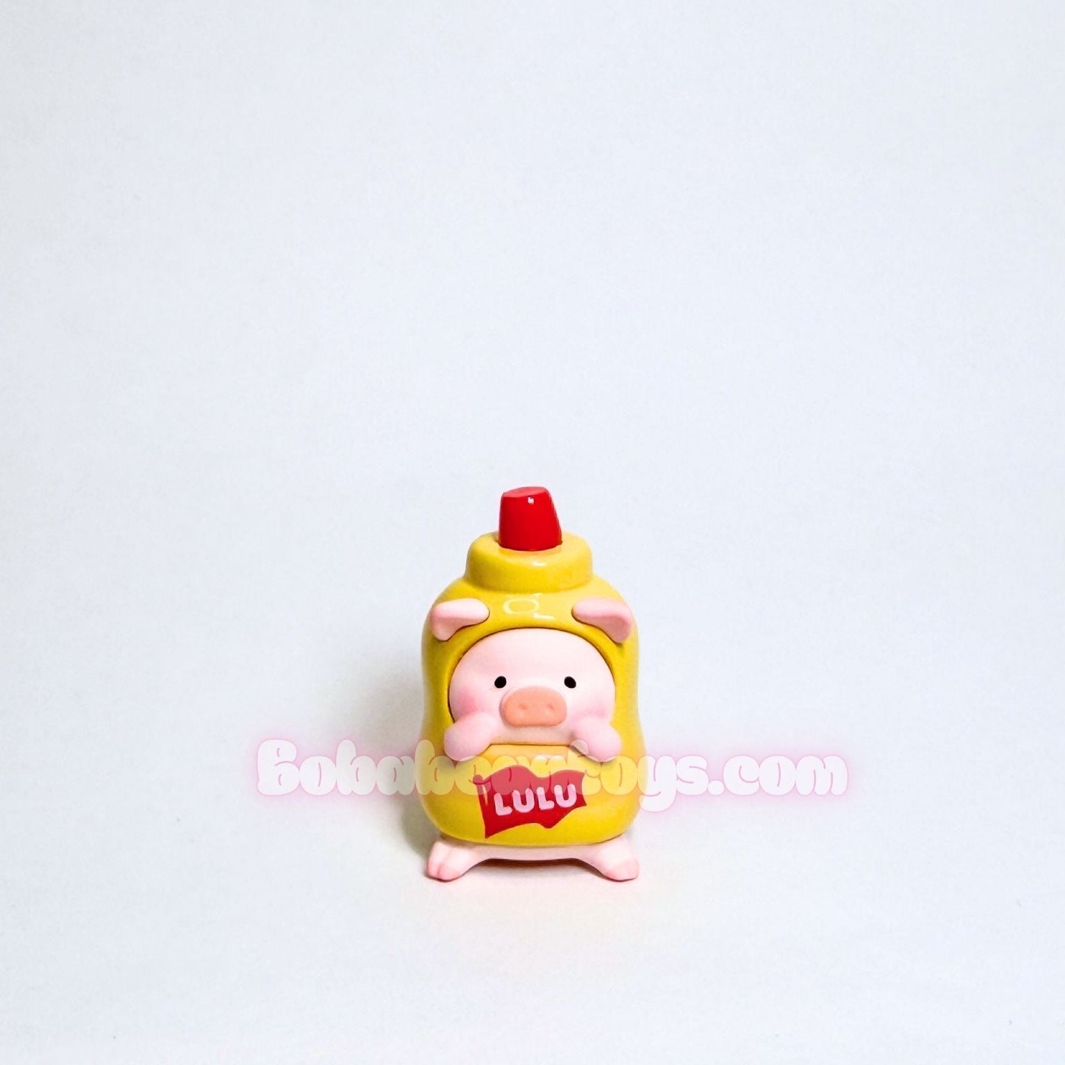 Small figurine of a cartoon character dressed as a yellow mustard bottle on a white background.